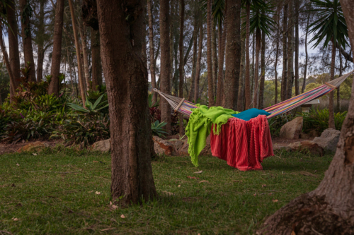 Hammock in nature with colourful pillow and blankets - Australian Stock Image