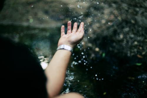 Hand playing with water