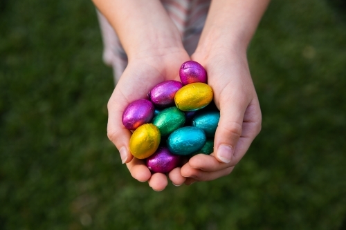 handful of easter eggs over a dark green background