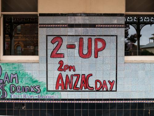 Handmade Two-Up sign on a tiled pub wall - Australian Stock Image