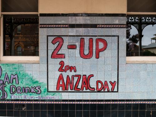 Handmade Two-Up sign on a tiled pub wall