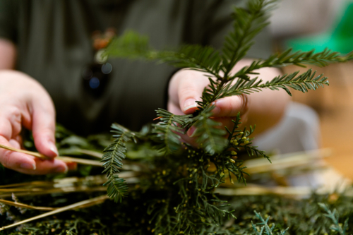 Hands creating a Christmas wreath - Australian Stock Image