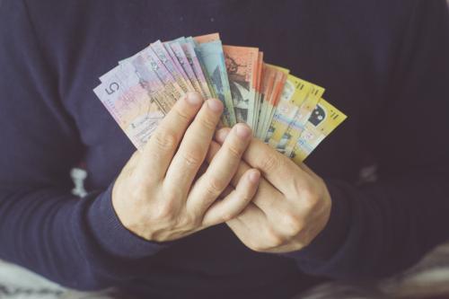 Hands holding a selection of Australian currency notes - Australian Stock Image