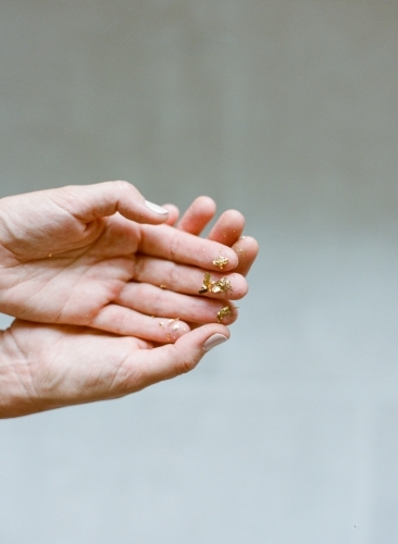 Hands holding little gold specks - Australian Stock Image