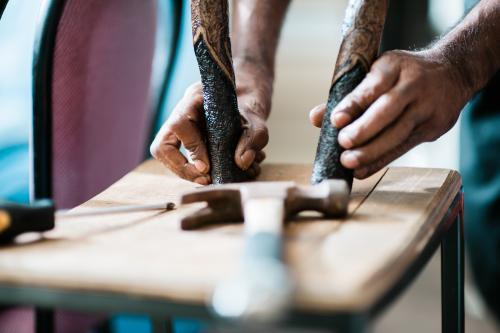 Hands of an Aboriginal Artist with Message Sticks - Australian Stock Image