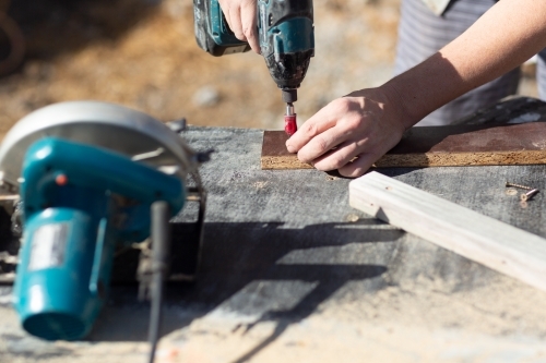 hands of handyman with power tools - Australian Stock Image