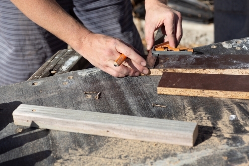 Hands of man measuring DIY project - Australian Stock Image
