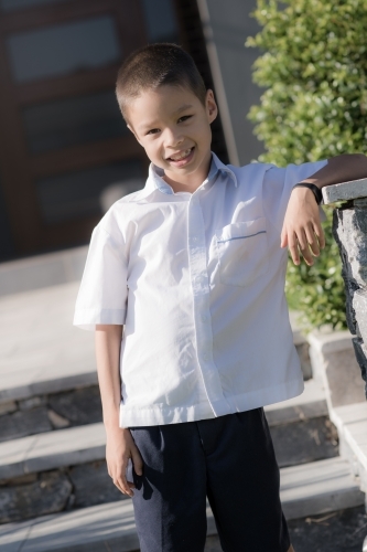 Handsome boys in school uniform leave home for their first day of school - Australian Stock Image