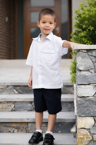 Handsome boys in school uniform leave home for their first day of school - Australian Stock Image