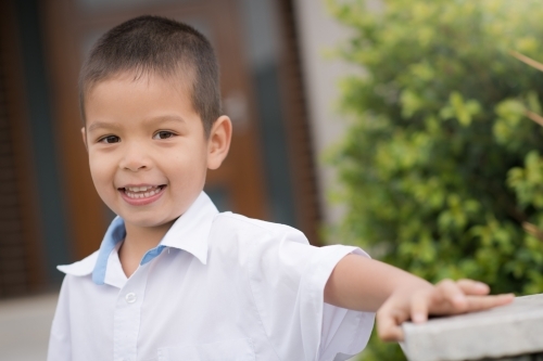Handsome boys in school uniform leave home for their first day of school - Australian Stock Image