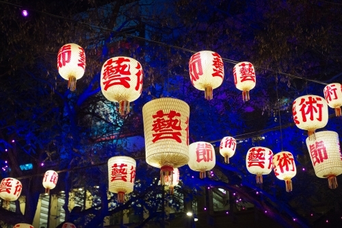 Hanging Chinese lanterns over pathway