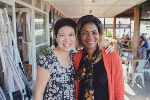 Happy Asian and African women - Australian Stock Image