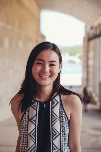 Happy Asian female young adult student in university - Australian Stock Image