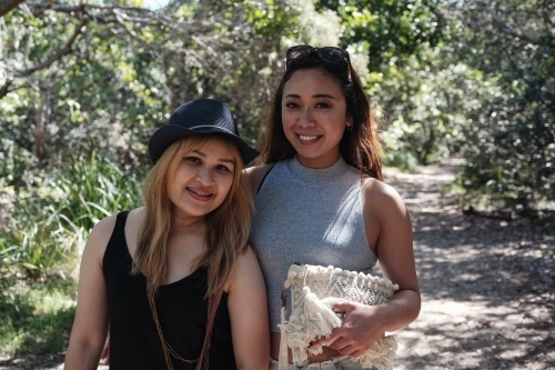 Happy Asian young adult women in the park - Australian Stock Image