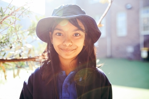 Happy Australian school student in the playground at school - Australian Stock Image