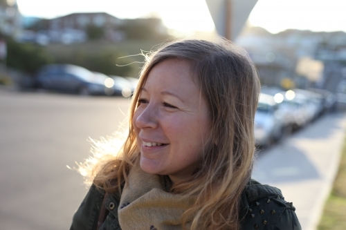 Happy blonde woman on footpath - Australian Stock Image