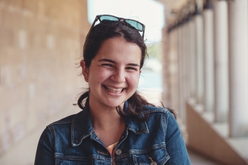Happy caucasian young female adult woman in university - Australian Stock Image