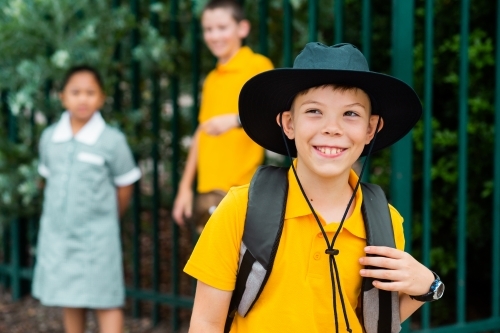 Happy cheeky school boy ready to go back to school - Australian Stock Image