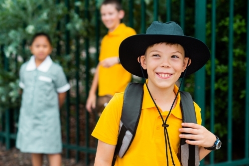 Happy cheeky school boy ready to go back to school