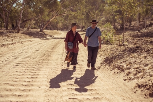 Happy elderly couple holding hands - Australian Stock Image
