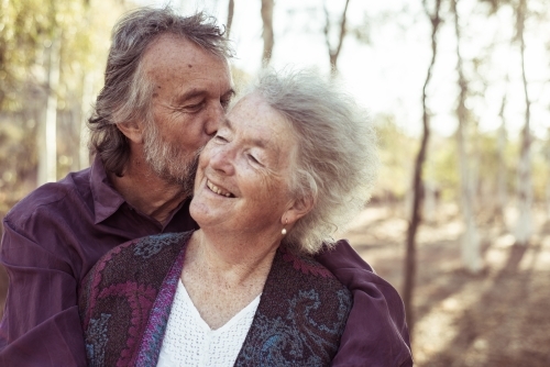 Happy elderly couple hug - Australian Stock Image
