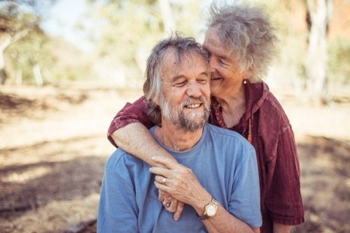 Happy elderly couple hug in the Northern Territory - Australian Stock Image