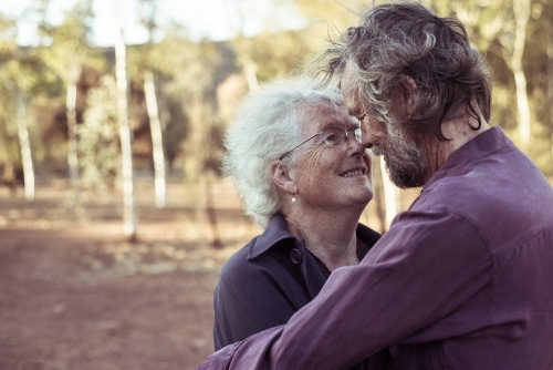 Happy elderly couple kiss in the Northern Territory - Australian Stock Image