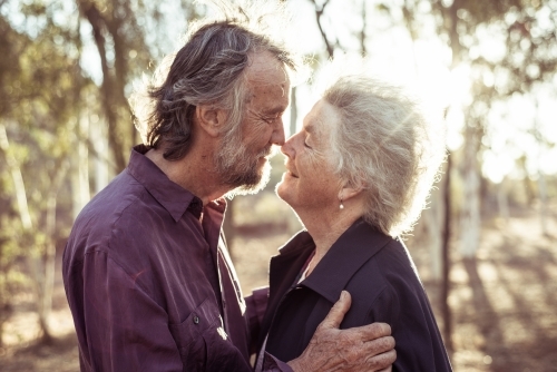 Happy elderly couple kiss in the Northern Territory - Australian Stock Image