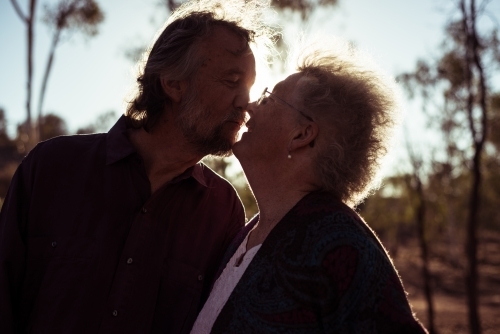 Happy elderly couple kiss in the Northern Territory - Australian Stock Image