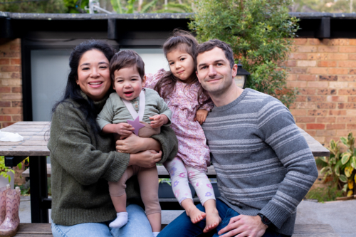 happy family portrait outside home - Australian Stock Image