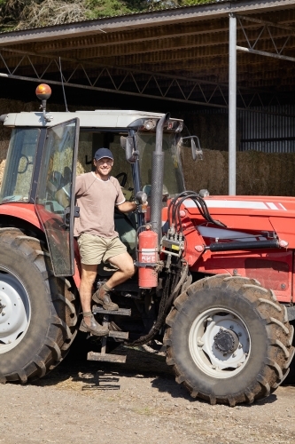 Happy farmer with his tractor