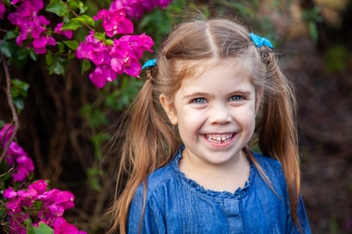 Happy little girl with gap in teeth from first lost tooth - Australian Stock Image