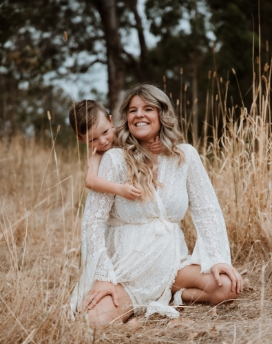 Happy mother and son together in field outside - Australian Stock Image