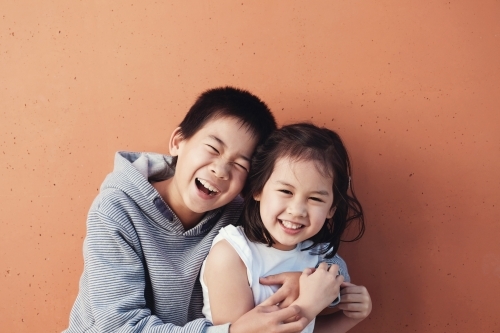 Happy multicultural boy and girl - Australian Stock Image