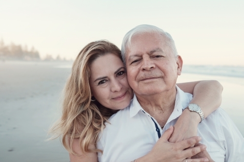 happy multicultural daughter and father on the beach - Australian Stock Image