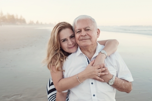 happy multicultural daughter and father on the beach - Australian Stock Image