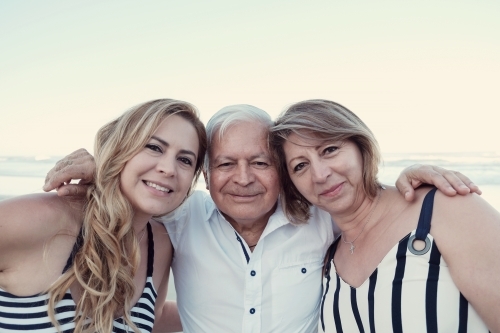 happy multicultural daughter and parents on the beach - Australian Stock Image