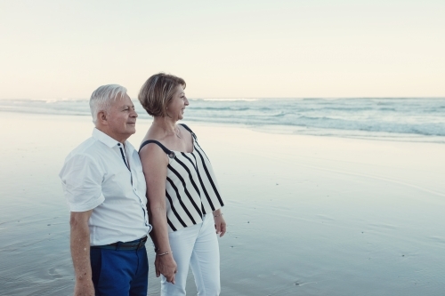 Happy multicultural senior couple on the beach - Australian Stock Image