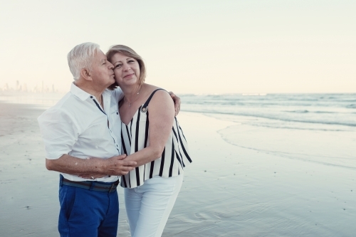 Happy multicultural senior couple on the beach - Australian Stock Image