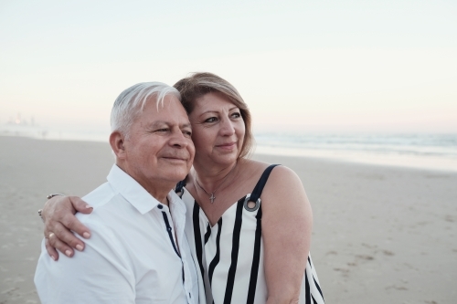 Happy multicultural senior couple on the beach - Australian Stock Image