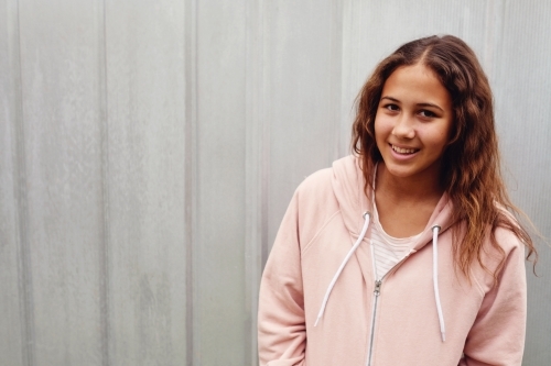 Happy multicultural teen girl with long hair - Australian Stock Image