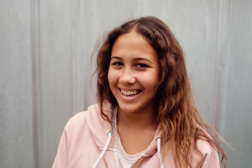 Happy multicultural teen girl with long hair - Australian Stock Image