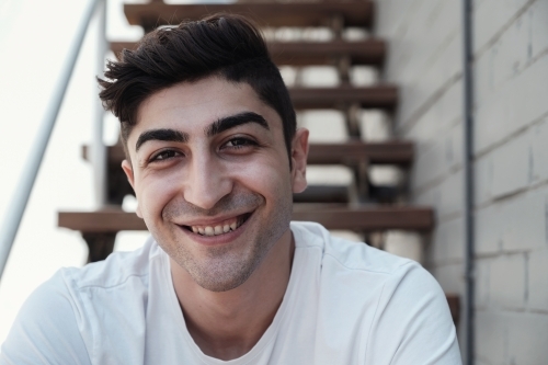 Happy multicultural young adult man, university student - Australian Stock Image