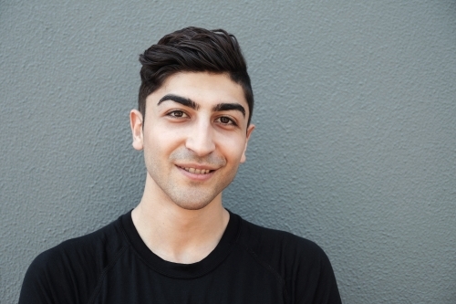Happy multicultural young adult man, university student - Australian Stock Image