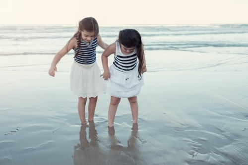 Happy multicultural young little girls on the beach - Australian Stock Image