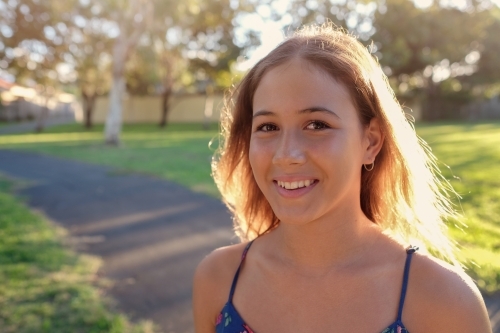 Happy multiethnic teenage girl in the park - Australian Stock Image