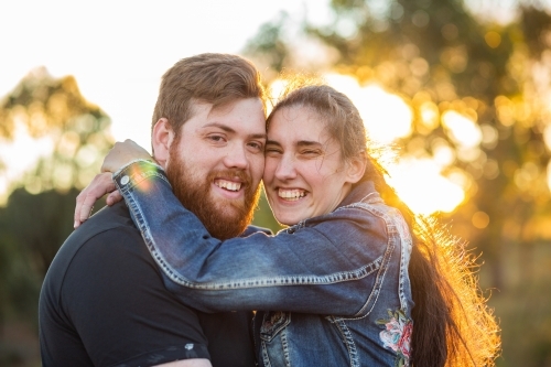 Happy smiling couple close up hugging each other - Australian Stock Image