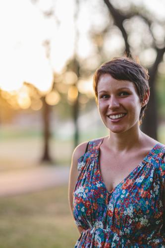 Happy smiling woman in summer dress at dusk - Australian Stock Image