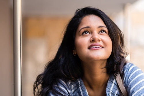 happy smiling woman looking up - Australian Stock Image