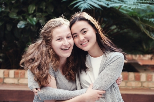 Happy students girl friends - Australian Stock Image